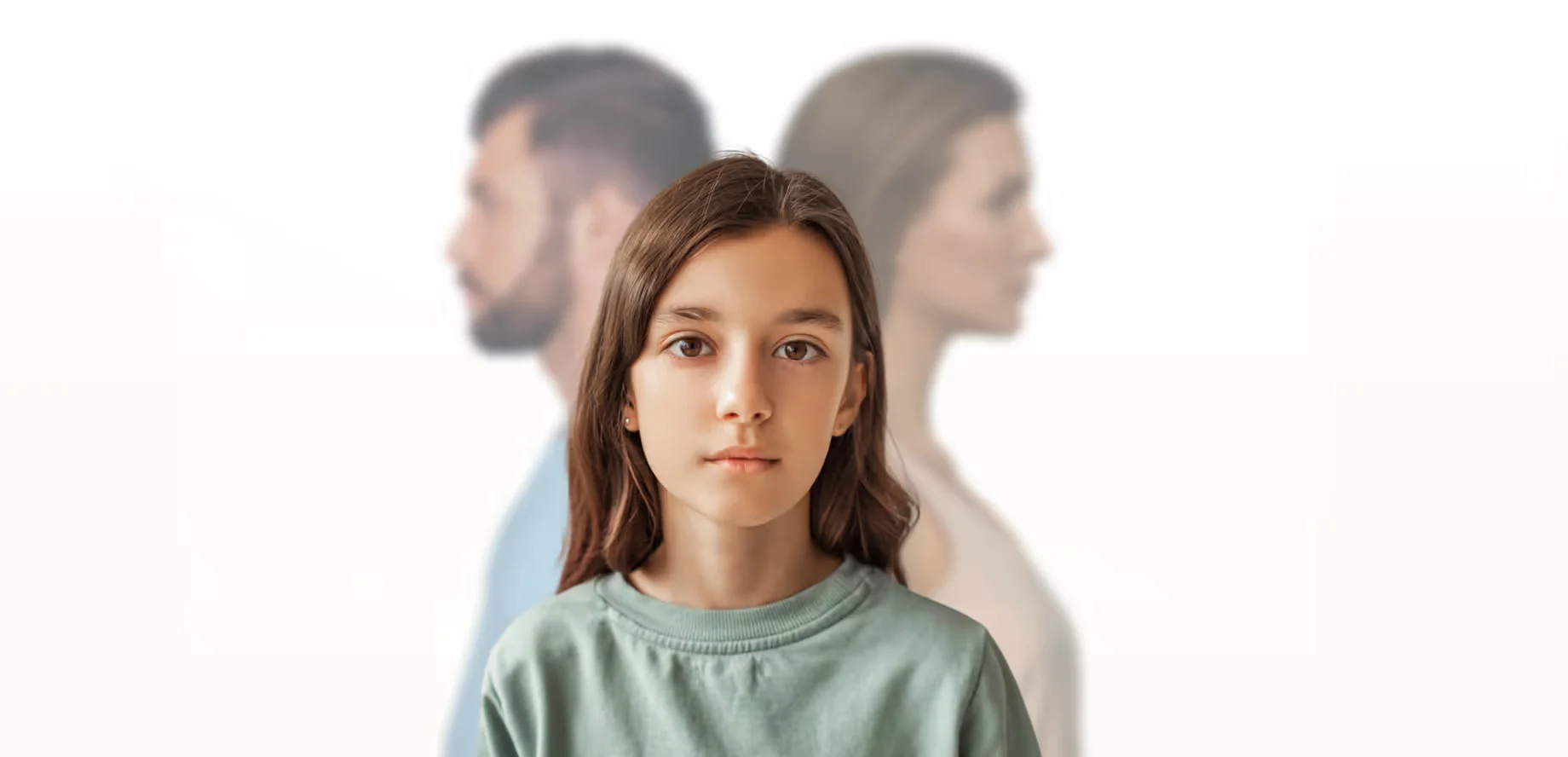A young girl stands confidently in front of a man, showcasing a moment of interaction between them.